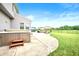 View of the backyard patio with hot tub, outdoor furniture, and manicured lawn at 1143 Hampton Dr, Greenwood, IN 46143