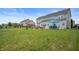 The backyard features a manicured lawn, patio with seating and a grey two-story home at 1143 Hampton Dr, Greenwood, IN 46143