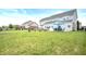 Expansive backyard with an outdoor dining area, privacy fence and stone retaining wall at 1143 Hampton Dr, Greenwood, IN 46143
