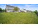 Spacious backyard with manicured lawn, seating area, hot tub and swing set at 1143 Hampton Dr, Greenwood, IN 46143