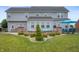 Large fenced backyard with covered patio and seating area perfect for entertaining guests at 1143 Hampton Dr, Greenwood, IN 46143