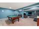 Finished basement with a pool table, a treadmill, and a seating area with a TV at 1143 Hampton Dr, Greenwood, IN 46143