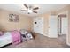 Bright bedroom featuring a ceiling fan, carpet flooring, and a closet with white doors at 1143 Hampton Dr, Greenwood, IN 46143