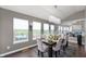 Elegant dining room features a modern chandelier, gray walls, and dark wood floors at 1143 Hampton Dr, Greenwood, IN 46143