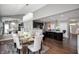 Open dining room flows into the kitchen with dark wood cabinets and a breakfast bar at 1143 Hampton Dr, Greenwood, IN 46143