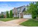 Beautiful two-story home with attached garage, blue shutters, and mature trees at 1143 Hampton Dr, Greenwood, IN 46143