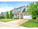 Lovely two-story home featuring a well-maintained lawn and attached two-car garage at 1143 Hampton Dr, Greenwood, IN 46143