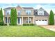Charming two-story brick home with a manicured lawn and inviting front porch at 1143 Hampton Dr, Greenwood, IN 46143