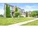 Beautiful two-story brick home with lush lawn, mature trees, and two-car garage at 1143 Hampton Dr, Greenwood, IN 46143