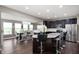 Eat-in kitchen boasts dark cabinetry, stainless steel appliances, and barstool seating at 1143 Hampton Dr, Greenwood, IN 46143