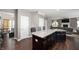 Modern kitchen island with granite countertops, dark cabinets, and open layout at 1143 Hampton Dr, Greenwood, IN 46143