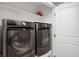 Updated laundry room featuring modern washer and dryer units and ample storage space at 1143 Hampton Dr, Greenwood, IN 46143