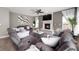 Comfortable living room with stone fireplace, large windows, and stylish decor at 1143 Hampton Dr, Greenwood, IN 46143