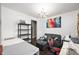 Cozy living room with a sofa, chandelier, dark hardwood floors, and an area for sewing at 1143 Hampton Dr, Greenwood, IN 46143