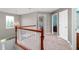 Second floor loft area with wood railing and several entryways at 1143 Hampton Dr, Greenwood, IN 46143