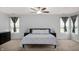 Spacious main bedroom with a ceiling fan, windows, dark side tables, and carpet flooring at 1143 Hampton Dr, Greenwood, IN 46143