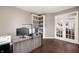 Home office with built-in shelves and glass French doors to another room at 1143 Hampton Dr, Greenwood, IN 46143