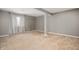 Spacious room with neutral carpet and walls, bright natural light, and a support beam at 1143 Hampton Dr, Greenwood, IN 46143