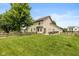 Spacious backyard with well-maintained lawn, patio area, and mature tree at 1159 Oak Leaf Rd, Franklin, IN 46131