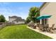 Lawn with a patio featuring outdoor seating, shaded by a bright blue umbrella at 1159 Oak Leaf Rd, Franklin, IN 46131
