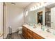 Bright bathroom featuring double sinks, a large mirror, and a walk-in closet at 1159 Oak Leaf Rd, Franklin, IN 46131