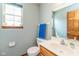 Cozy bathroom features a vanity, toilet, and a framed window for natural light at 1159 Oak Leaf Rd, Franklin, IN 46131