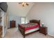 Carpeted bedroom with a large bed, a ceiling fan, and natural light through the window at 1159 Oak Leaf Rd, Franklin, IN 46131