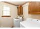 Functional laundry area with washer, dryer, and storage cabinets near a bright window at 1159 Oak Leaf Rd, Franklin, IN 46131