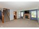 Cozy living room featuring a brick fireplace, plush carpet, and stairs at 1159 Oak Leaf Rd, Franklin, IN 46131
