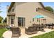 A patio with outdoor seating and a grill for entertaining in a backyard at 1159 Oak Leaf Rd, Franklin, IN 46131