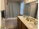Bright bathroom featuring a double sink vanity with a shower-tub combo and decorative shower curtain at 12328 Quarry Face Ct, Fishers, IN 46037
