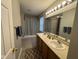 Bright bathroom featuring a double sink vanity with a shower-tub combo and decorative shower curtain at 12328 Quarry Face Ct, Fishers, IN 46037
