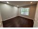 Well-lit bedroom with hardwood floors and neutral wall colors at 12328 Quarry Face Ct, Fishers, IN 46037