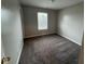 A simple bedroom with neutral walls, carpeted floors and window with blinds, providing natural light at 12328 Quarry Face Ct, Fishers, IN 46037