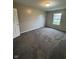 A simple bedroom with neutral walls, carpeted floors and window with blinds, providing natural light at 12328 Quarry Face Ct, Fishers, IN 46037