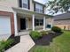Inviting front porch with black mulch landscaping around the house's foundation at 12328 Quarry Face Ct, Fishers, IN 46037