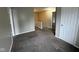 Upstairs hallway with neutral walls and carpet with two doorways into other rooms and a linen closet at 12328 Quarry Face Ct, Fishers, IN 46037