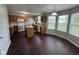 A spacious kitchen with wooden cabinets, an island, white appliances and a breakfast nook with large windows at 12328 Quarry Face Ct, Fishers, IN 46037