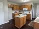 Functional kitchen with an island, wooden cabinets, and laminate countertops at 12328 Quarry Face Ct, Fishers, IN 46037