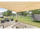 Spacious backyard featuring a covered patio, outdoor seating, and a well-maintained lawn at 126 Winding Brook Way, Pendleton, IN 46064
