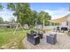 A sprawling backyard with an outdoor dining area, a fire pit, a swing set, and a trampoline at 126 Winding Brook Way, Pendleton, IN 46064