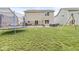 Spacious backyard with grass, patio furniture, trampoline, and a swing set perfect for outdoor enjoyment at 126 Winding Brook Way, Pendleton, IN 46064