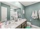 A clean bathroom features a double vanity, a large mirror, and grey-painted walls at 126 Winding Brook Way, Pendleton, IN 46064