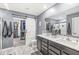 Modern bathroom with double sinks, barn door to closet, and a large mirror, creating a spa-like experience at 126 Winding Brook Way, Pendleton, IN 46064