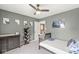 A cozy carpeted bedroom features grey walls, a ceiling fan, and -friendly decor at 126 Winding Brook Way, Pendleton, IN 46064