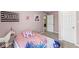 Carpeted bedroom with pink walls, white door, and views into an attached bathroom at 126 Winding Brook Way, Pendleton, IN 46064