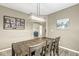 Charming dining room with a rustic wooden table, a modern chandelier, neutral walls, and decorative artwork at 126 Winding Brook Way, Pendleton, IN 46064