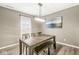 Dining room featuring a rustic wooden table with bench seating, pendant lighting, and a large window at 126 Winding Brook Way, Pendleton, IN 46064
