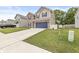 Well-maintained two-story home with brick accents, blue garage door, and a spacious driveway at 126 Winding Brook Way, Pendleton, IN 46064