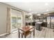 Charming kitchen featuring dark cabinetry, island, stainless appliances, and glass sliding door to the backyard at 126 Winding Brook Way, Pendleton, IN 46064